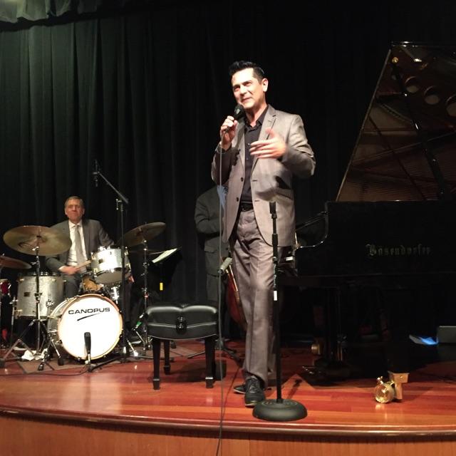 Tony Pacini speaking to the audience at world-wide simulcast concert; Chuck Redd drums. Not visible: Ed Bennett bass, Tim Rap percussion. Pictured: Bosendorfer 280 Vienna Concert Piano.